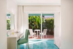a room with a desk and a table and chairs at Hotel Continental Mare in Ischia Town