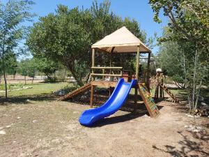 a playground with a slide and a gazebo at Cabañas Llepu in Linares