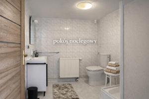 a bathroom with a toilet and a sink at Pokój noclegowy in Józefowo