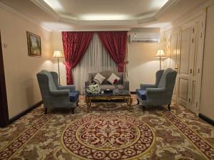 a living room with two chairs and a couch at Taj Celine Hotel in Jeddah