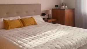 a bedroom with a large white bed with yellow pillows at Yellow Room - Sunlite Double Private Room in Villa Barbuja in Tefía