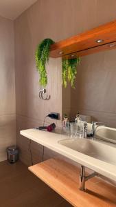 a bathroom counter with a sink and a mirror at Yellow Room - Sunlite Double Private Room in Villa Barbuja in Tefía +12 photos