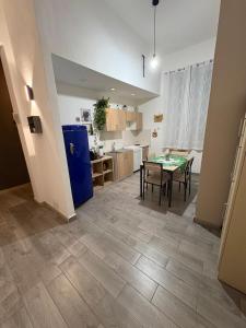 a living room with a table and a kitchen at DAREB HOME vista mare in Agrigento +26 photos
