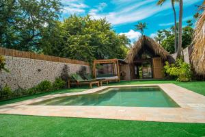 a swimming pool in a yard with a house at Hotel Isla Mucura in Isla Mucura