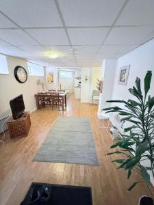a living room with a table and a clock on the wall at CentRum turistlogi in Borås