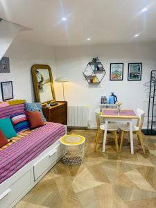 a bedroom with a bed and a dining room table at Duplex house with small terrace in Bayeux