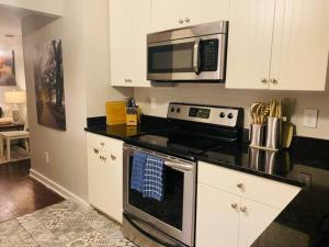 a kitchen with a stove and a microwave at The Hourglass Inn- Unit B in Savannah