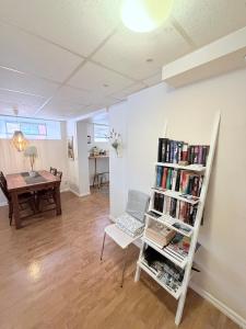 a living room with a book shelf filled with books at CentRum turistlogi in Borås