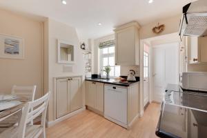 a kitchen with white cabinets and a counter top at 2 Bed in Southwold oc-twi2 in Southwold