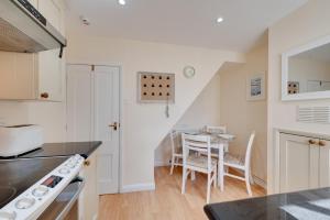 a kitchen with a table and a dining room at 2 Bed in Southwold oc-twi2 in Southwold