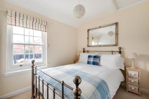 a bedroom with a bed and a mirror at 2 Bed in Southwold oc-twi2 in Southwold