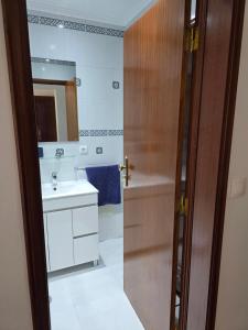 a bathroom with a sink and a mirror at Gorgeous House in Ponta Delgada