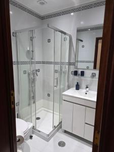a bathroom with a shower and a toilet and a sink at Gorgeous House in Ponta Delgada
