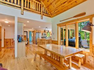 a kitchen and dining room with a wooden table in a room at Sunset Serenity on Kego Lake in Fifty Lakes