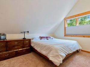 a bedroom with a bed with a dresser and a window at Sunset Serenity on Kego Lake in Fifty Lakes
