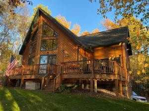 a large log cabin with a large deck at Sunset Serenity on Kego Lake in Fifty Lakes