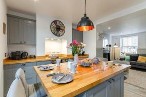 a kitchen with a table with plates and flowers on it at 2 Bed in Holt oc-p27287 in Holt