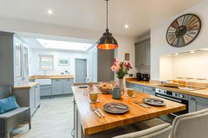 a kitchen with a wooden table with plates on it at 2 Bed in Holt oc-p27287 in Holt +10 photos