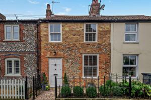 an old brick house with a white door at 2 Bed in Holt oc-p27287 in Holt