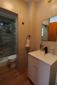 a bathroom with a sink and a toilet and a mirror at CASA ETEN Hospedaje Boutique - centro histórico de Cajamarca in Cajamarca
