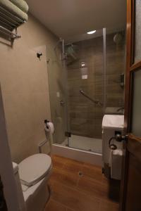 a bathroom with a shower and a toilet and a sink at CASA ETEN Hospedaje Boutique - centro histórico de Cajamarca in Cajamarca +19 photos