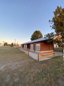 a small house is sitting in a field at Cabañas Emilia in La Adela