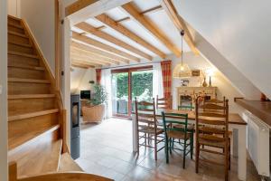 a kitchen and dining room with a table and chairs at Riet&Rust in Lanaken