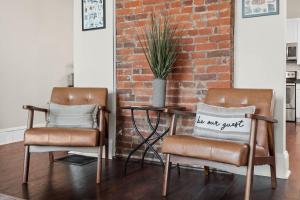 two chairs sitting next to a table with a pillow at Derby & Bourbon Trail Homebase W Private Backyard in Louisville