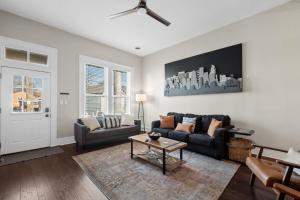 a living room with a couch and a table at Derby & Bourbon Trail Homebase W Private Backyard in Louisville