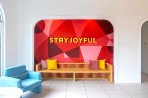 a room with a bench and a sign that readsstay joyfully at The Gallatin in Nashville