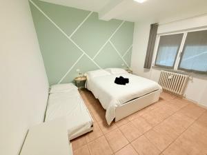 a bedroom with two beds and a window at Cà par durmì in Gravellona Toce