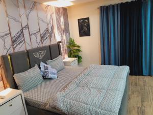 a bedroom with a bed and a couch with pillows at Urban Pearl Apartment in Rawalpindi