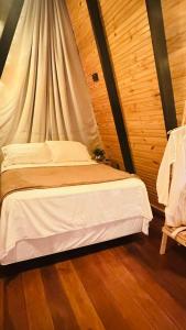 a bedroom with a bed with a canopy at Fabulosas da Serra in Monte das Gameleiras