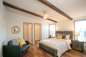 a bedroom with a bed and a chair at Sun Outdoors Rocky Mountains in Granby +87 photos
