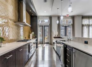 a large kitchen with stainless steel appliances and counters at The Residences At La Cantera in San Antonio