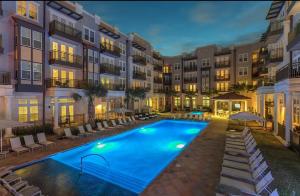 a swimming pool in front of a building at The Residences At La Cantera in San Antonio