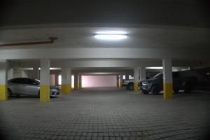 a parking garage with cars parked in it at GRAN PALAZZO Hotel in Villa Gesell