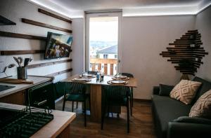 a living room with a table and a couch at La Canopée Jurassienne in Les Rousses