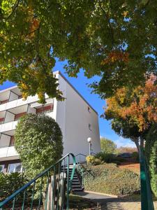 a white building with stairs in front of it at MeLou Fewo Harzruhe Wellness in Bad Lauterberg