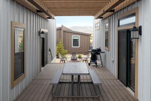 a deck with a picnic table on a house at Sun Outdoors Rocky Mountains in Granby