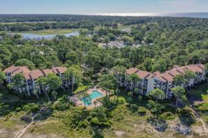 an aerial view of an apartment complex with a pool and trees at Beachside Tennis 1869 in Hilton Head Island