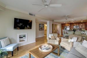 a living room with a couch and a table at Beachside Tennis 1869 in Hilton Head Island