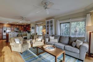 a living room with a couch and a table at Beachside Tennis 1869 in Hilton Head Island