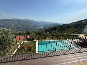 a balcony with a view of a swimming pool at Retiro Vale do Douro in Vila Marim