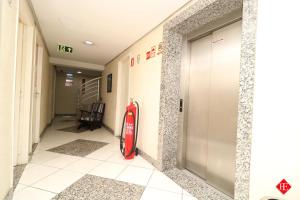 a fire extinguisher in a hallway of a building at Hotel Elevado in Porto Alegre