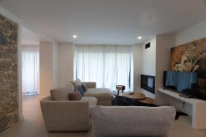 a living room with a couch and a flat screen tv at Golden View in Vale de Tábuas