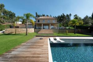 a home with a swimming pool and a house at Golden View in Vale de Tábuas