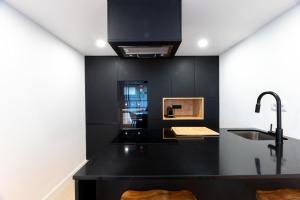 a kitchen with a black counter and a sink at Golden View in Vale de Tábuas