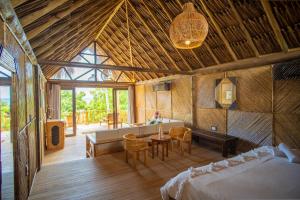 a large room with a bed and a table and chairs at Hotel Isla Mucura in Isla Mucura +223 photos