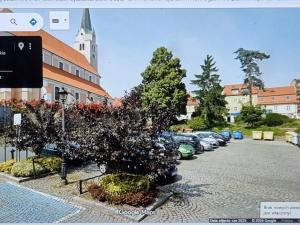 a parking lot with cars parked in front of a building at Apartament Sobótka in Sobótka
